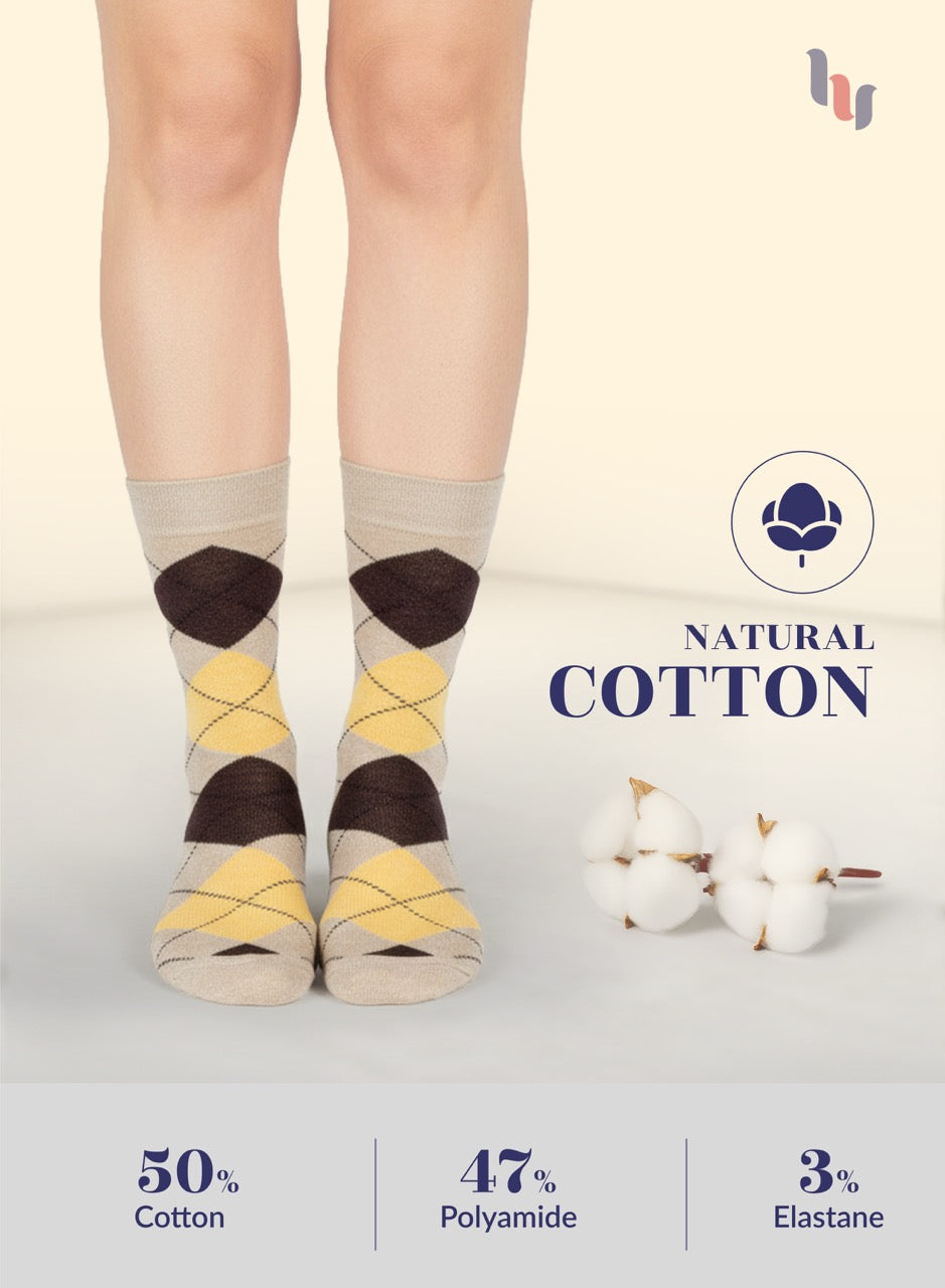 Person wearing patterned Beige socks with natural cotton label and ingredient information on a light background