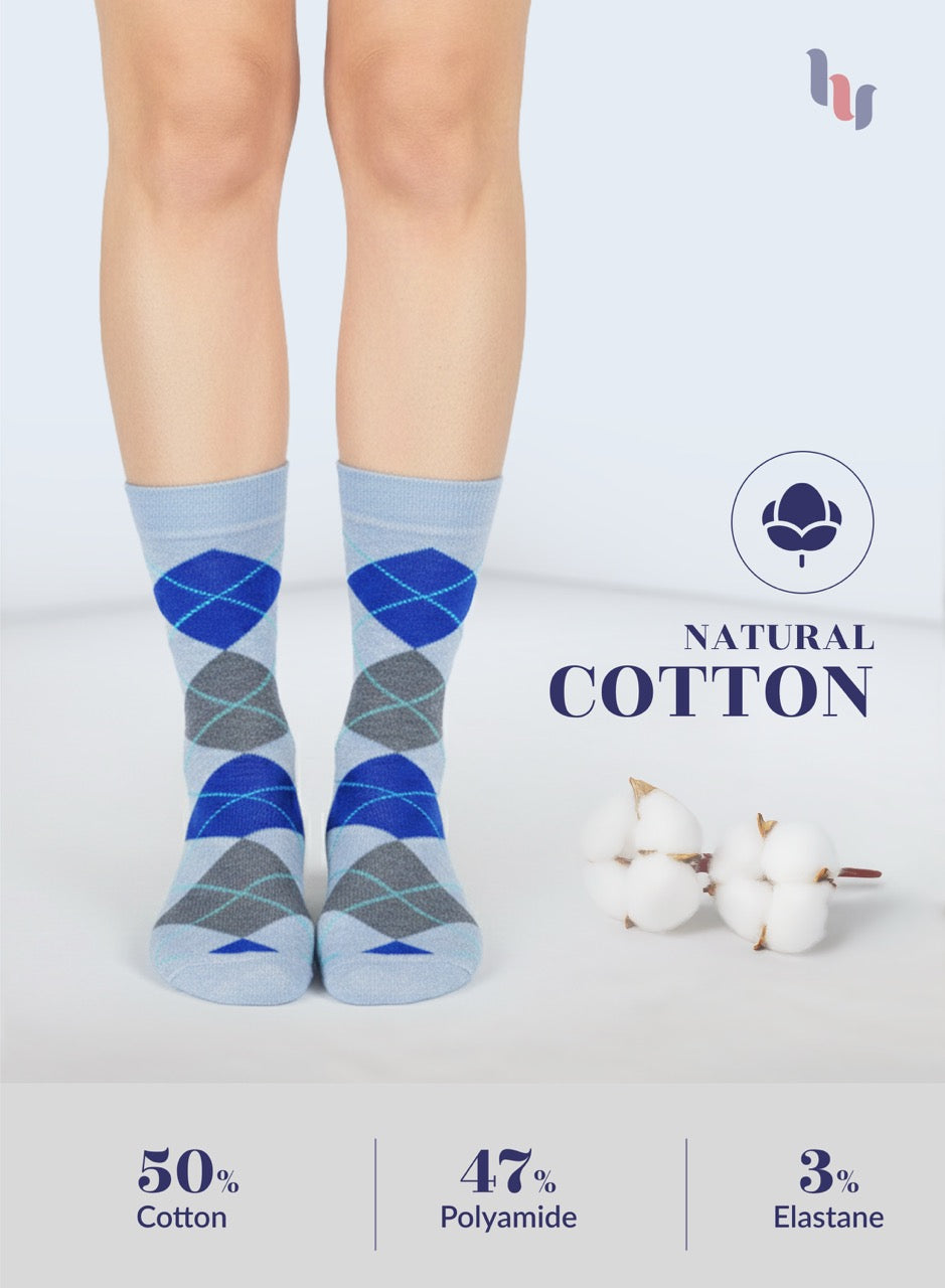 Blue and gray patterned socks worn by a person, with 'Natural Cotton' label and cotton plant illustration on a light blue background.