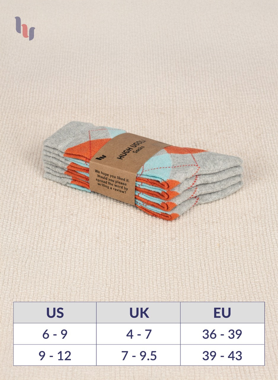 Pack of Light Grey socks with a label on a beige fabric background, featuring a size chart below.