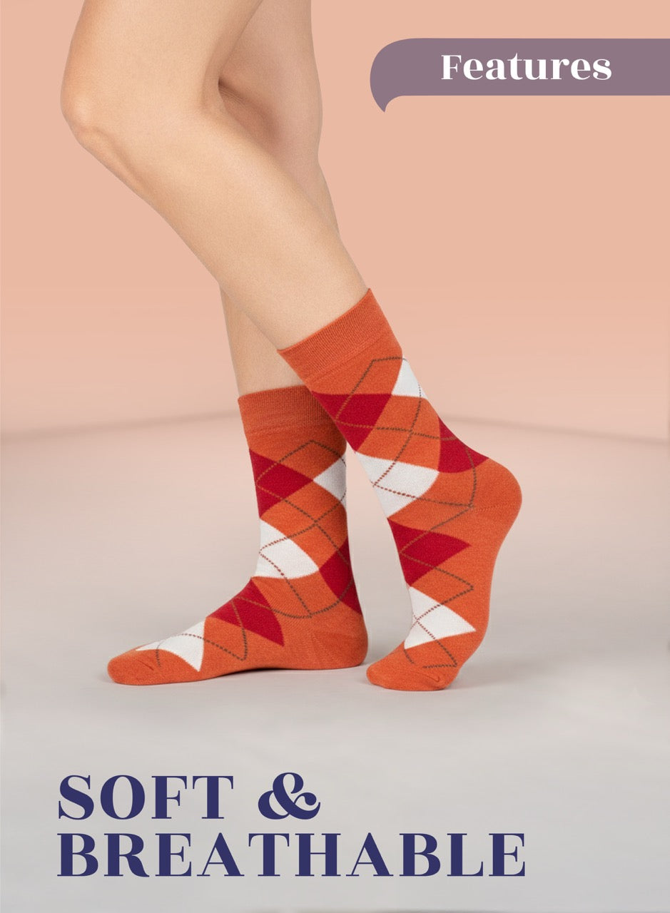 Orange and Dark Red argyle socks worn by a person on a light pink background with 'Features' and 'Soft & Breathable' text.