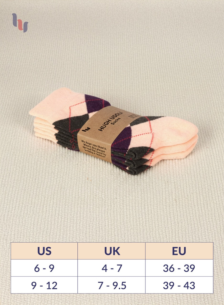 Pack of peach and black checkered socks with a size chart on a beige background