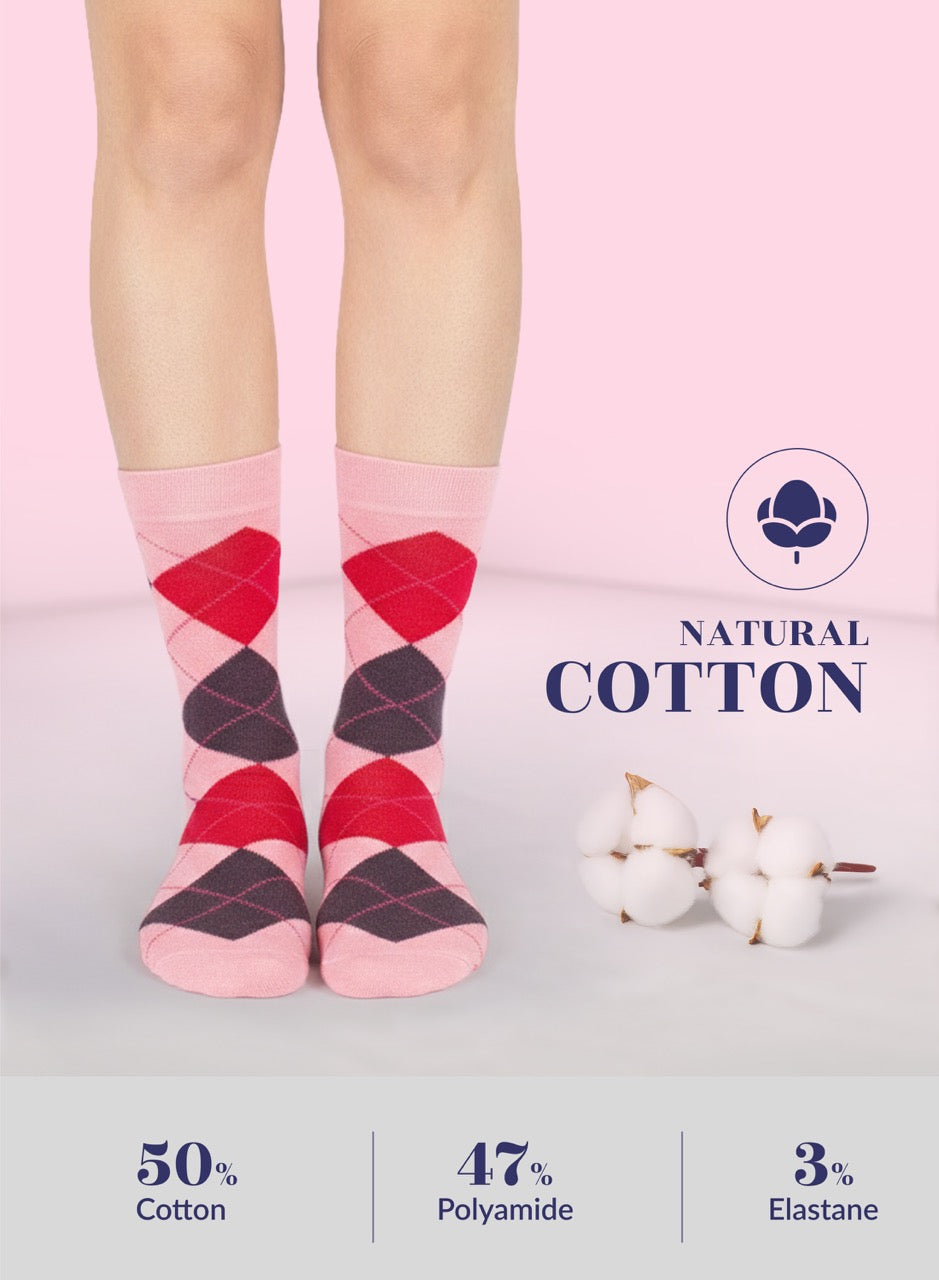 Pink argyle socks with natural cotton label on a light pink background