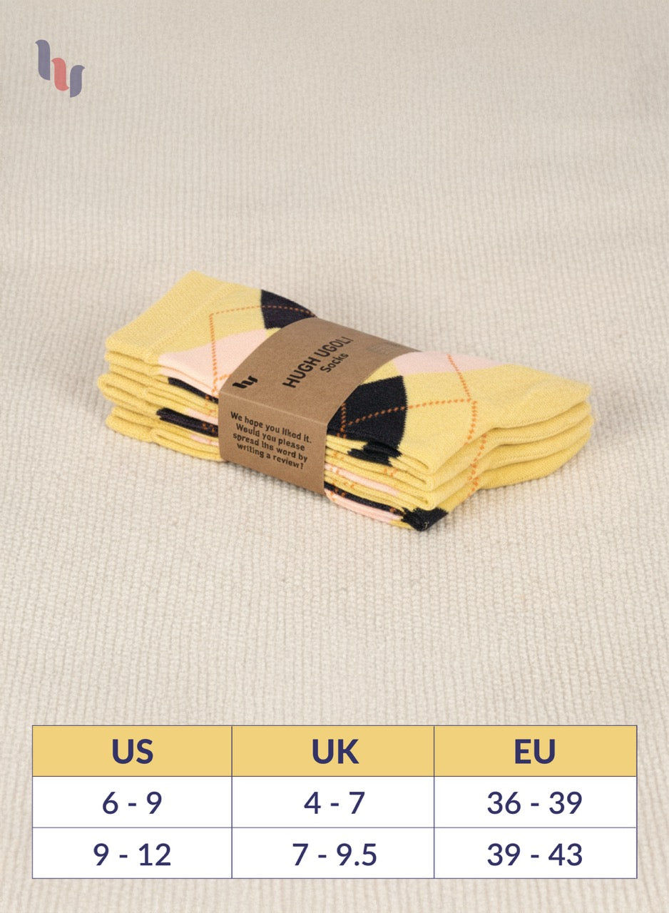 Pack of yellow socks with a size chart on a beige fabric background