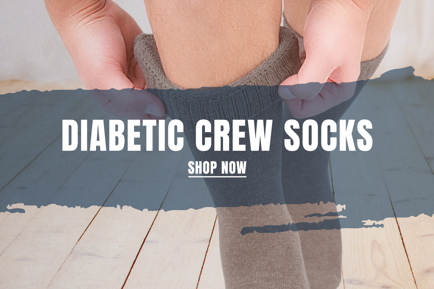Hugh Ugoli - Diabetic Crew Socks - Close-up of hands adjusting gray diabetic crew socks with a non-binding elastic top designed for comfort and improved circulation