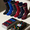 Set of colorful polka dot socks with packaging on a light background