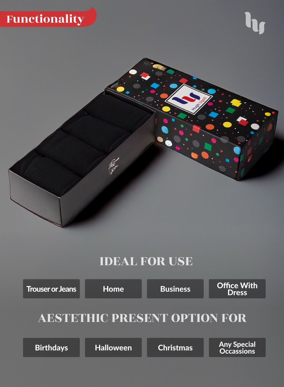 Black socks with box with colorful polka dot design on a gray background