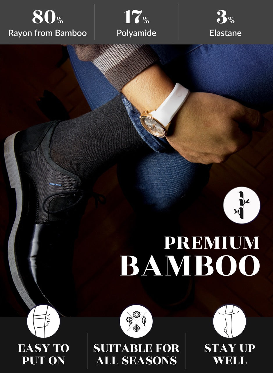 Person wearing black shoes, charcoal socks, and a white watch with text on fabric composition and features.