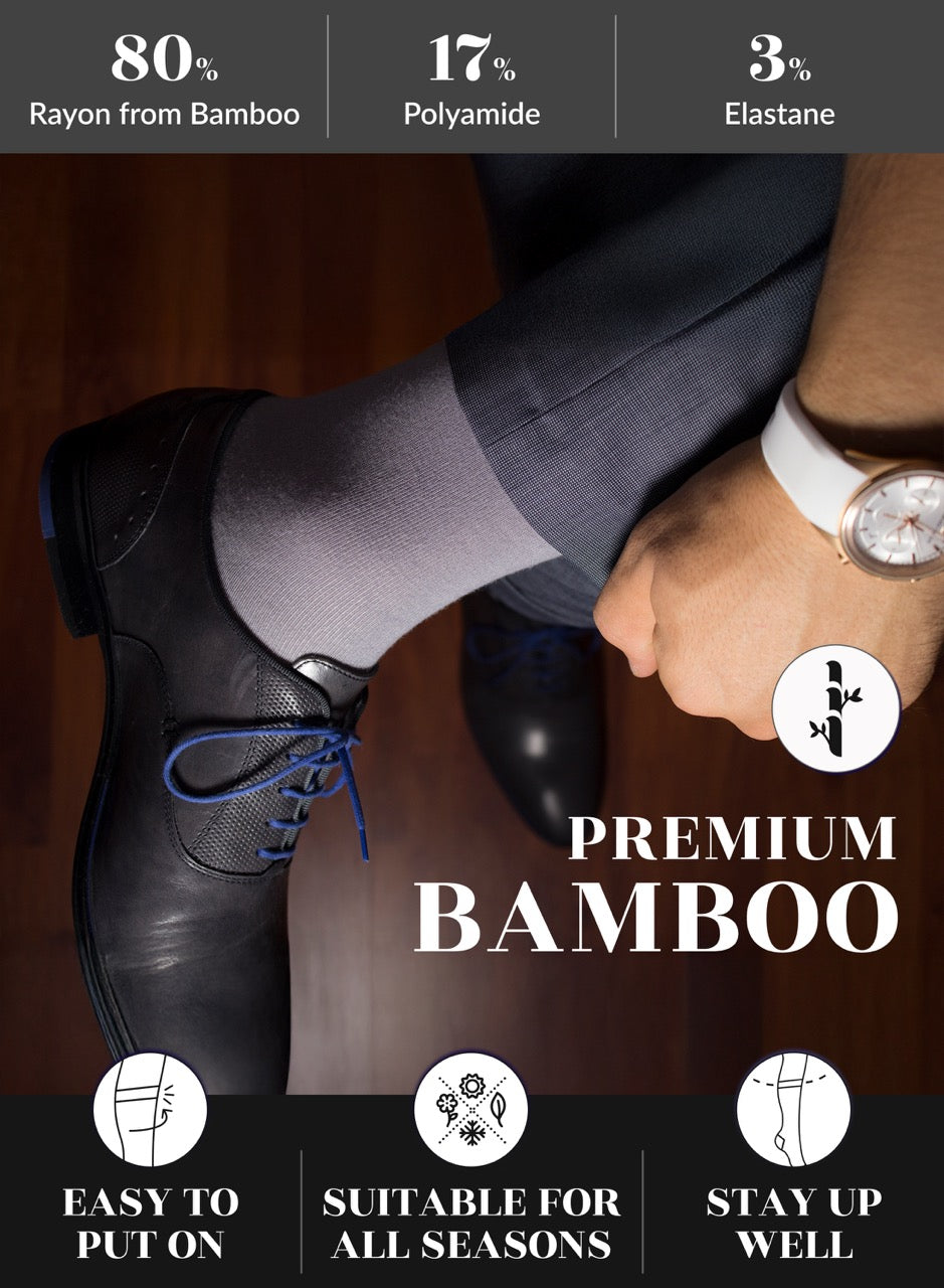 Person wearing black shoes and Light Gray bamboo socks with product features highlighted.