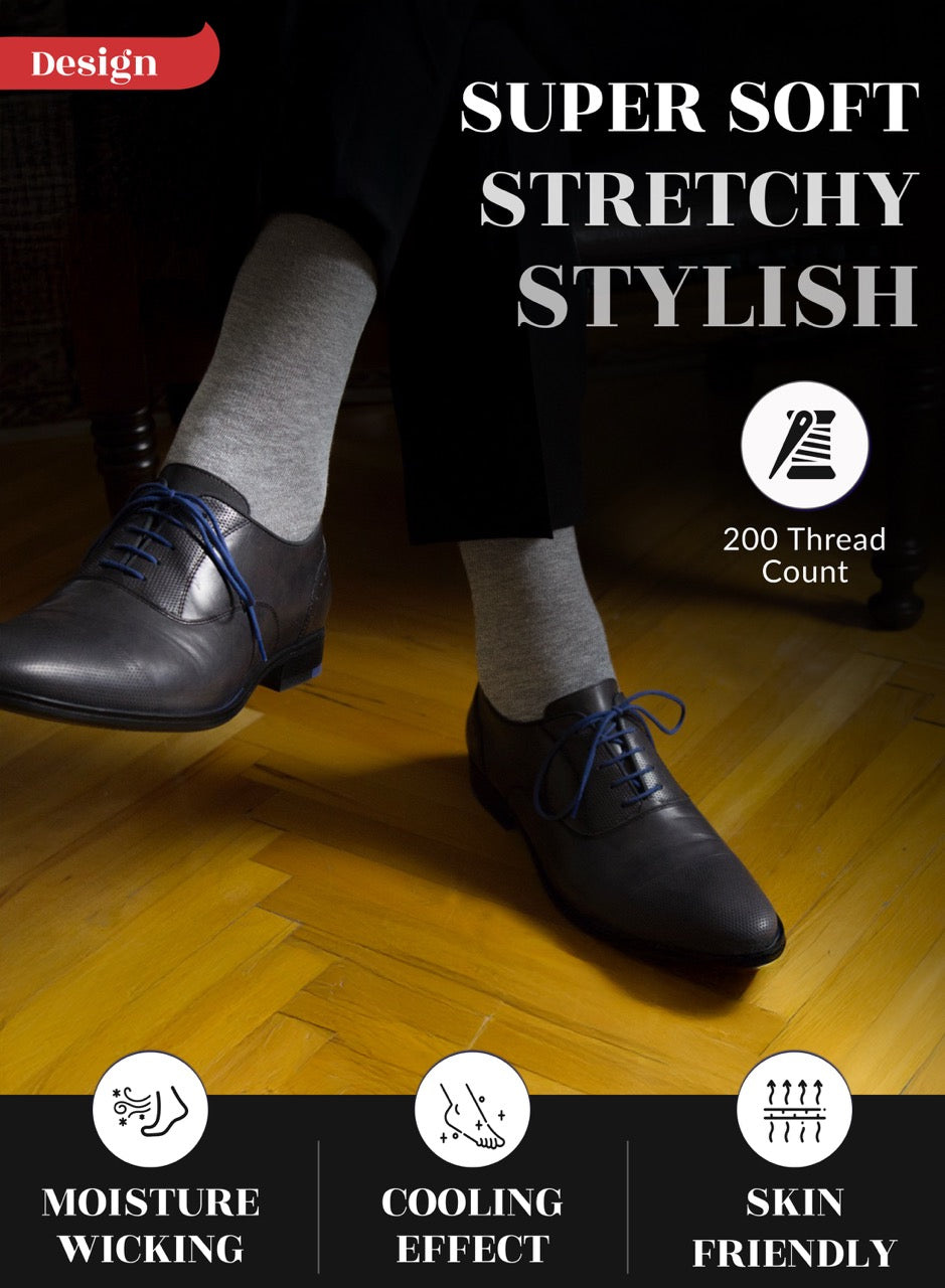 Person wearing black shoes and light gray socks on a wooden floor with text highlighting shoe features.