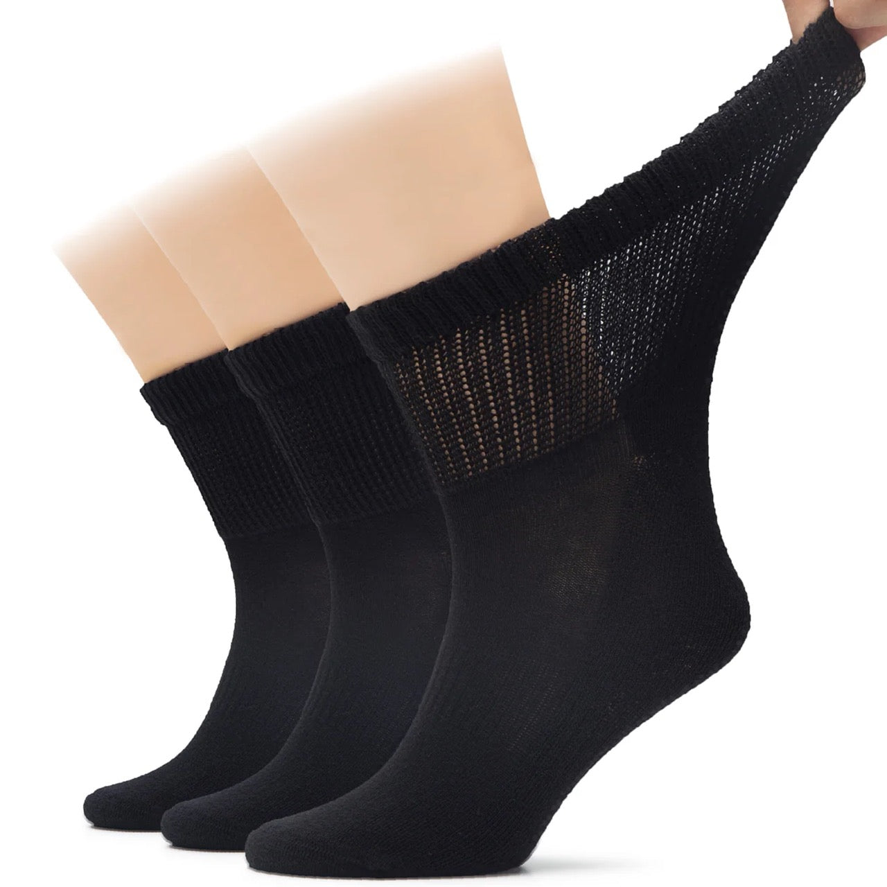 Three pairs of black socks with a textured pattern on a white background