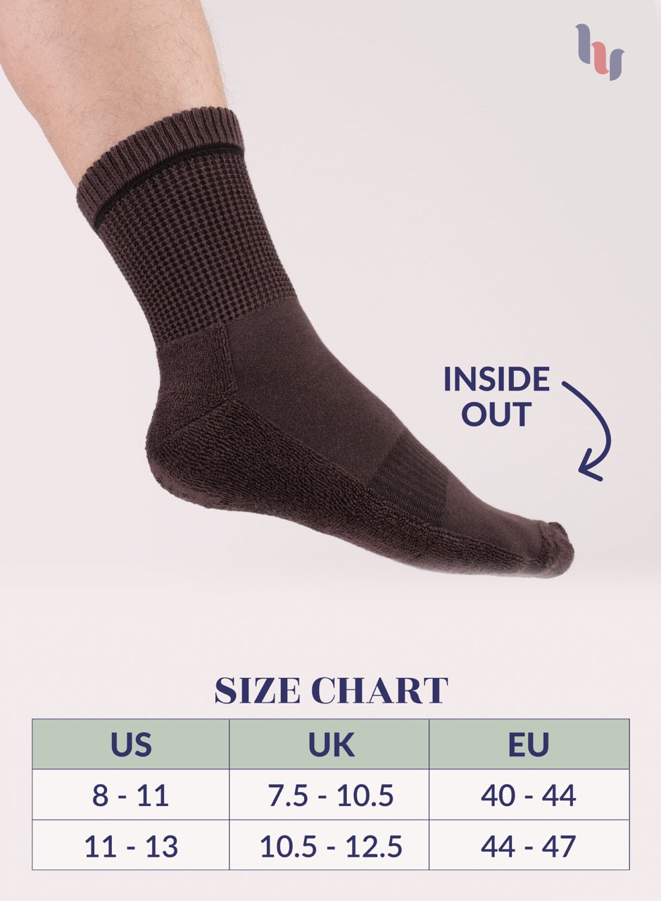 Dark Brown sock on a foot with size chart below on a light gray background
