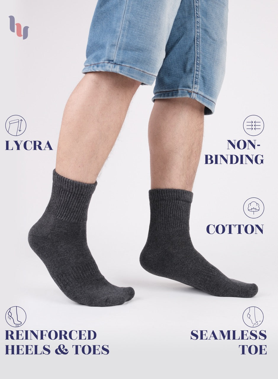 Dark Gray socks worn with denim shorts on a white background, featuring LYCRA, non-binding, cotton, reinforced heels & toes, and seamless toe text.