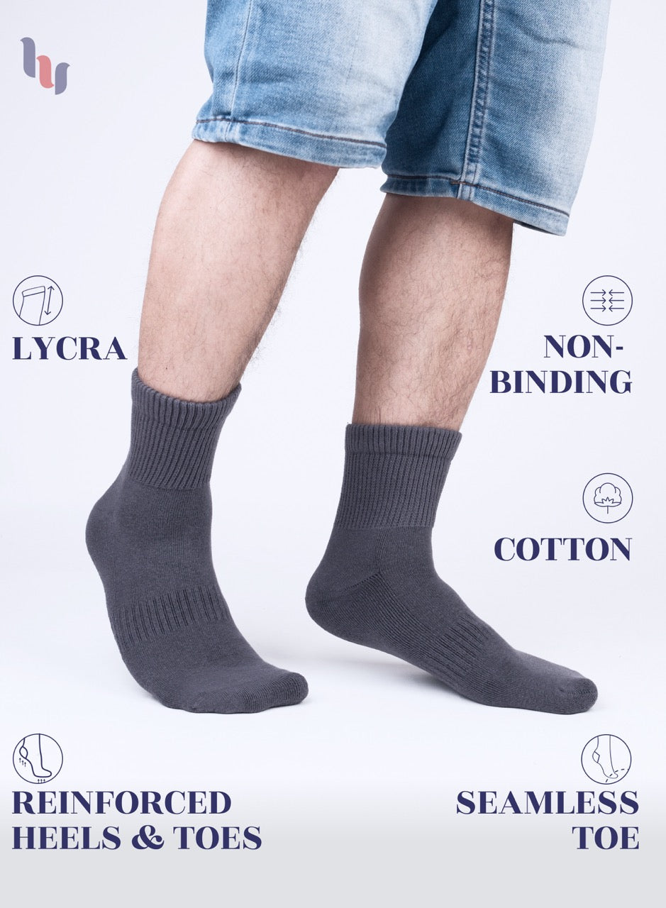 Gray socks worn with denim shorts on a white background, featuring LYCRA and non-binding cotton text.