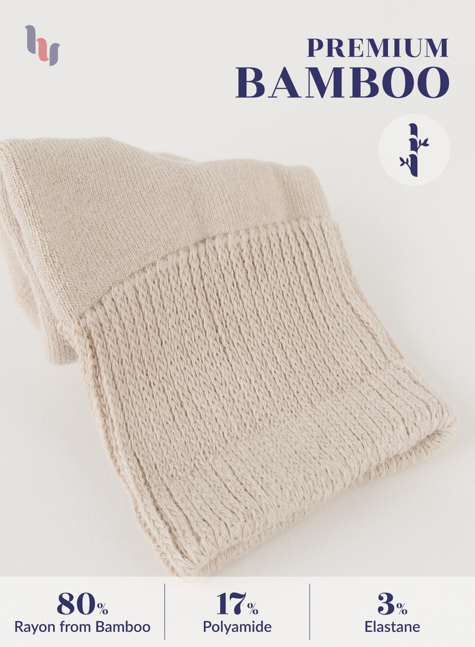 Light Beige knitted blanket with bamboo text and fabric composition details on a white background