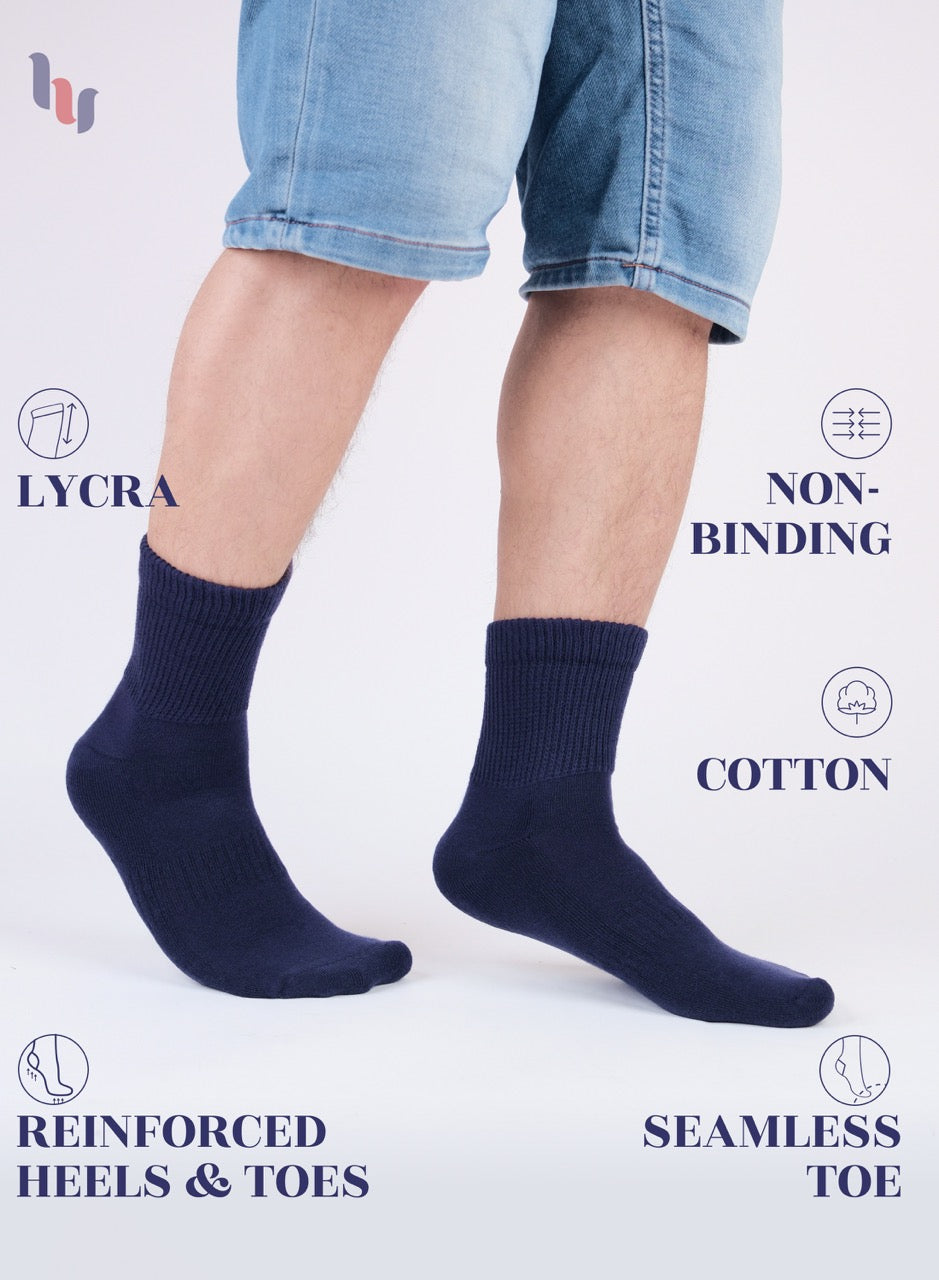 Navy blue socks worn with denim shorts on a white background, featuring LYCRA and non-binding text.