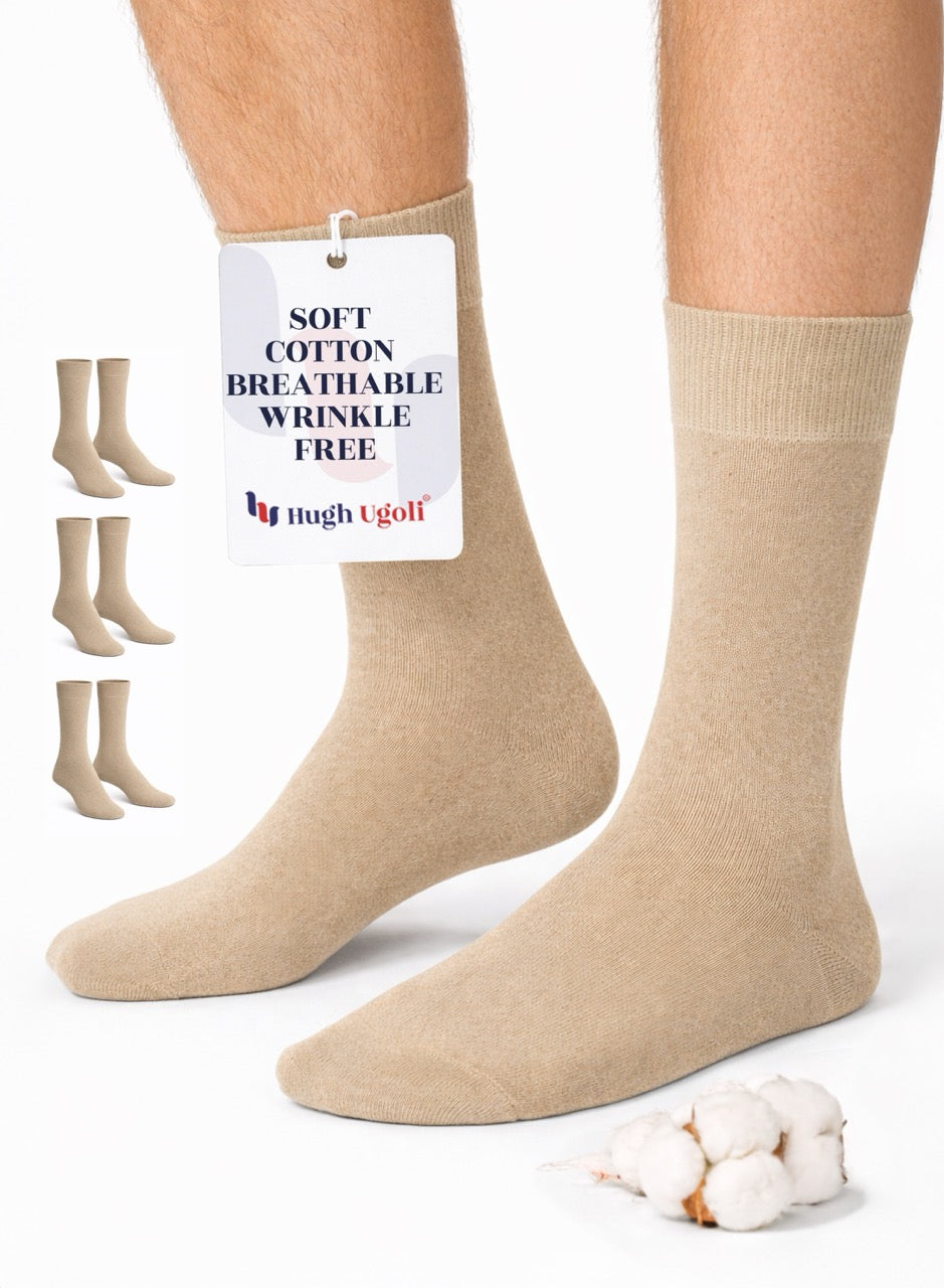 Beige socks with a tag on a white background, featuring the brand 'Hugh Ugolf'.