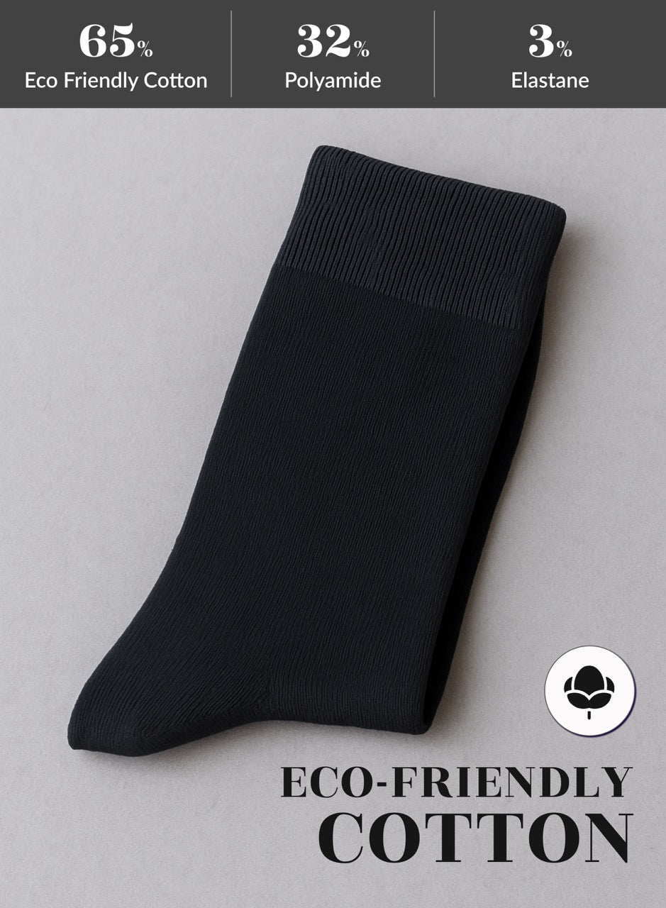 Black sock on a gray background with eco-friendly cotton label