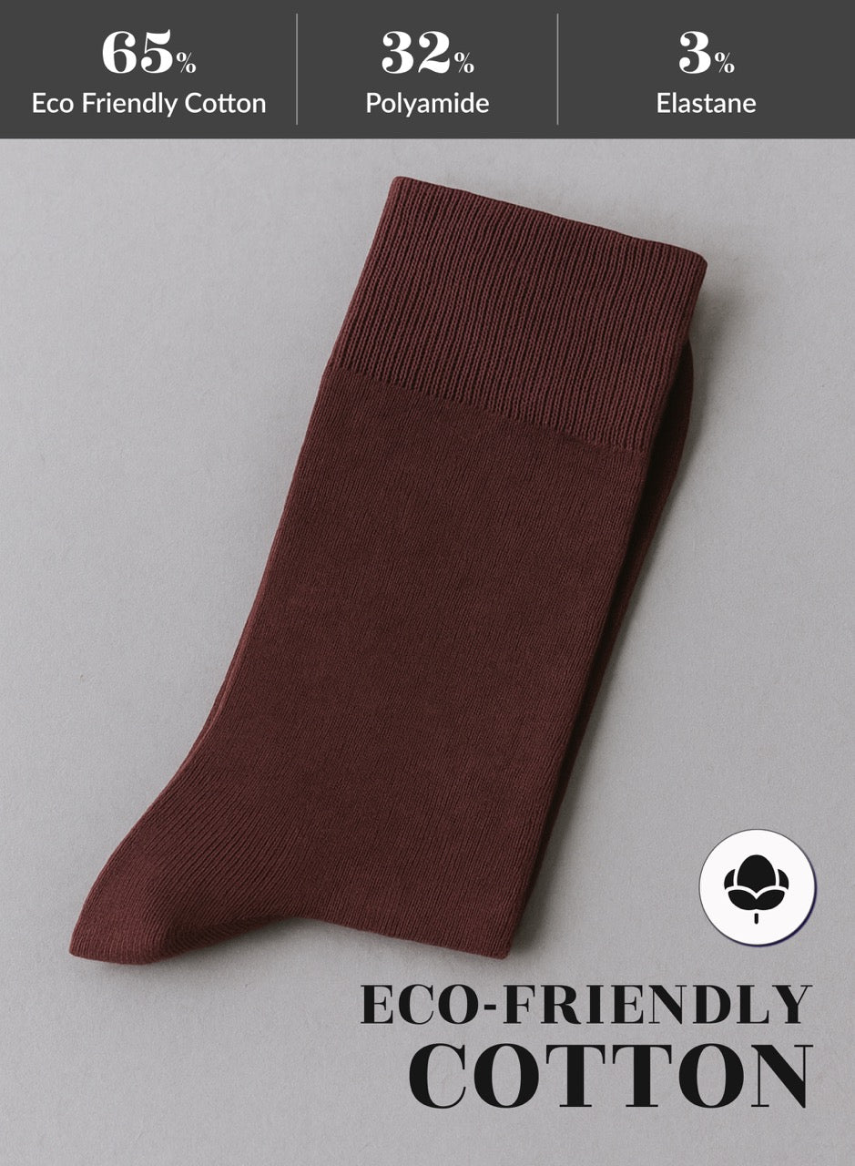Burgundy sock on a gray background with eco-friendly cotton label