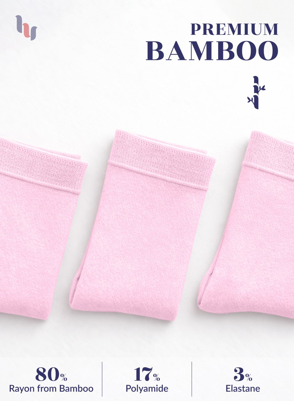 Three pink bamboo products on a white background with text indicating material composition.