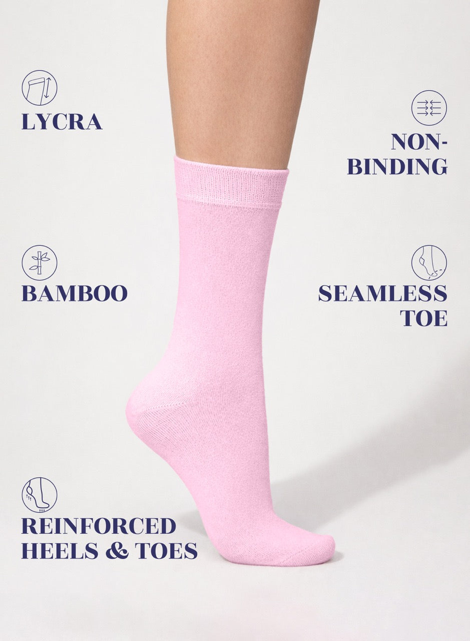 Pink sock on a white background with text highlighting features like Lycra, non-binding, bamboo, seamless toe, and reinforced heels & toes.
