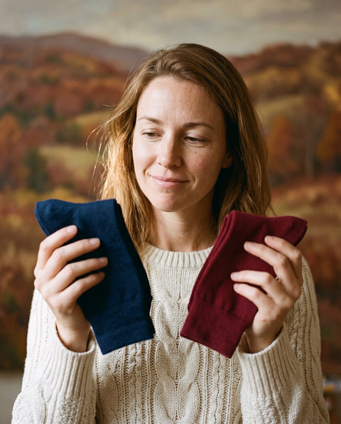 A woman choosing between two pairs of socks