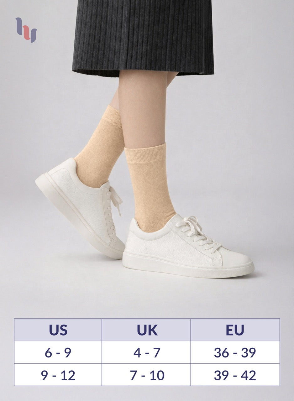 Person wearing beige socks with white sneakers on a light gray background, with a size chart below.