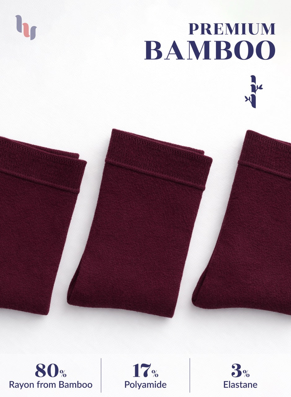 Three burgundy bamboo socks on a white background with text indicating material composition.