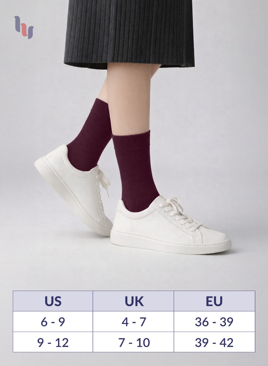 Person wearing Burgundy socks with white sneakers on a light gray background, with a size chart displayed below.