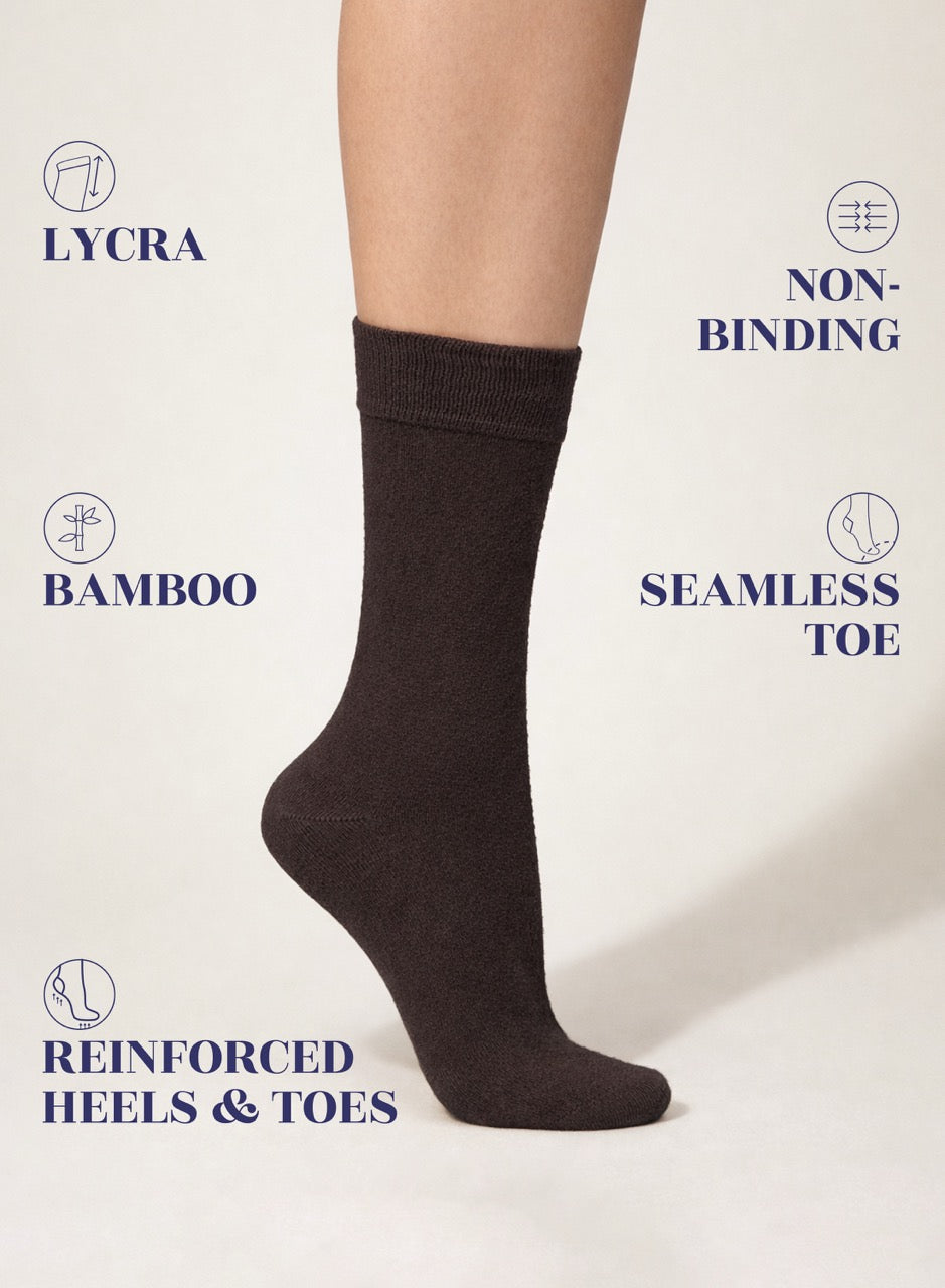 Dark brown sock on a white background with text highlighting features like Lycra, non-binding, bamboo, seamless toe, and reinforced heels & toes.