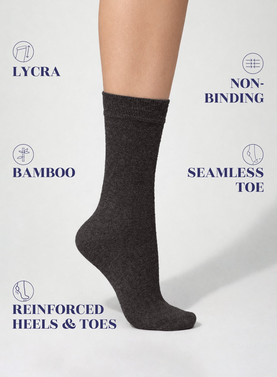 Dark gray sock on a white background with text highlighting features like Lycra, non-binding, bamboo, seamless toe, reinforced heels & toes.