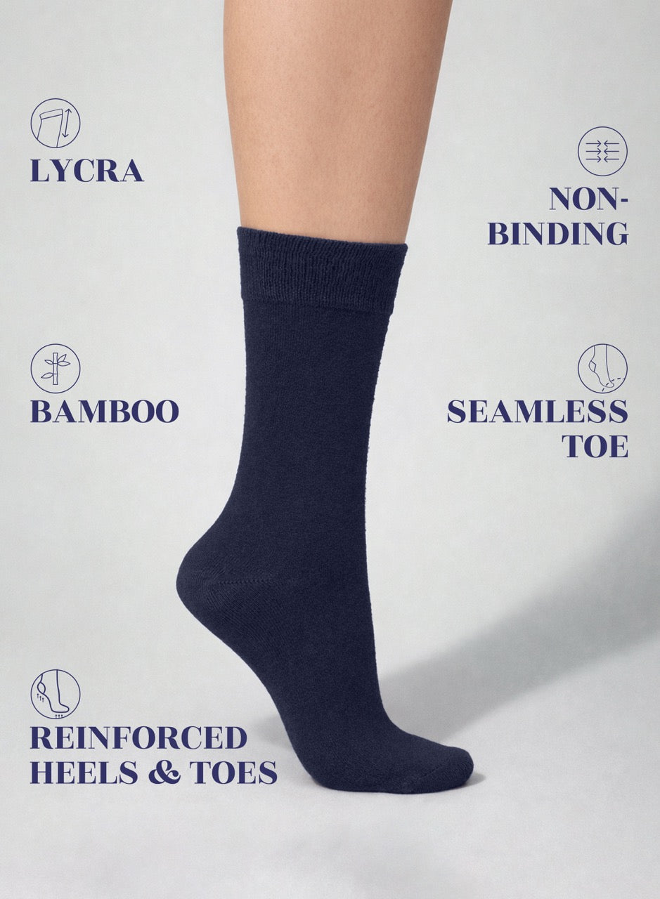 Navy blue sock on a white background with text highlighting features like Lycra, non-binding, bamboo, seamless toe, and reinforced heels & toes.
