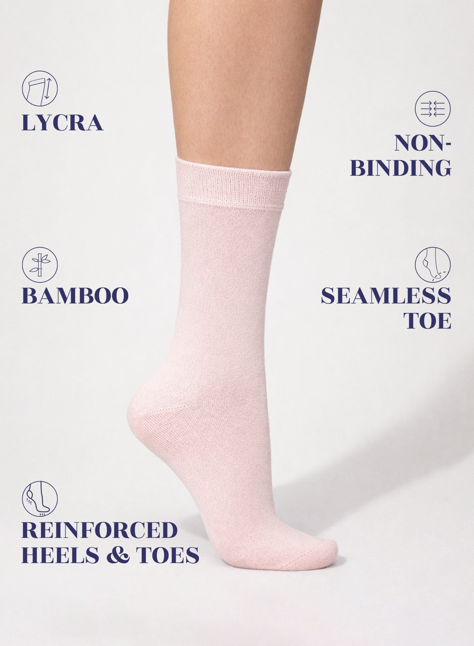 pink sock on a white background with text highlighting features like Lycra, non-binding, bamboo, seamless toe, reinforced heels, and toes.