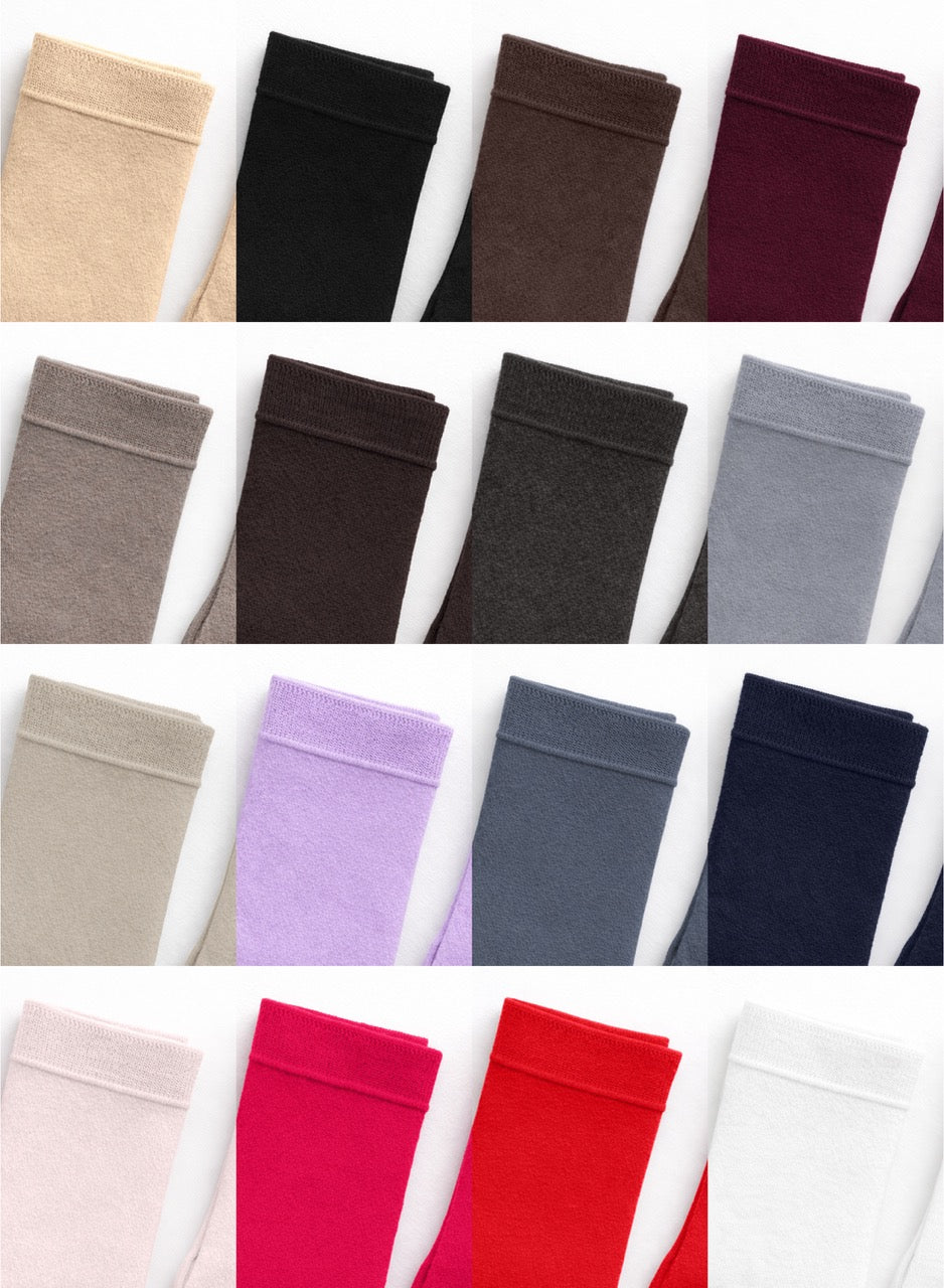 Collection of folded fabric swatches in various colors on a white background