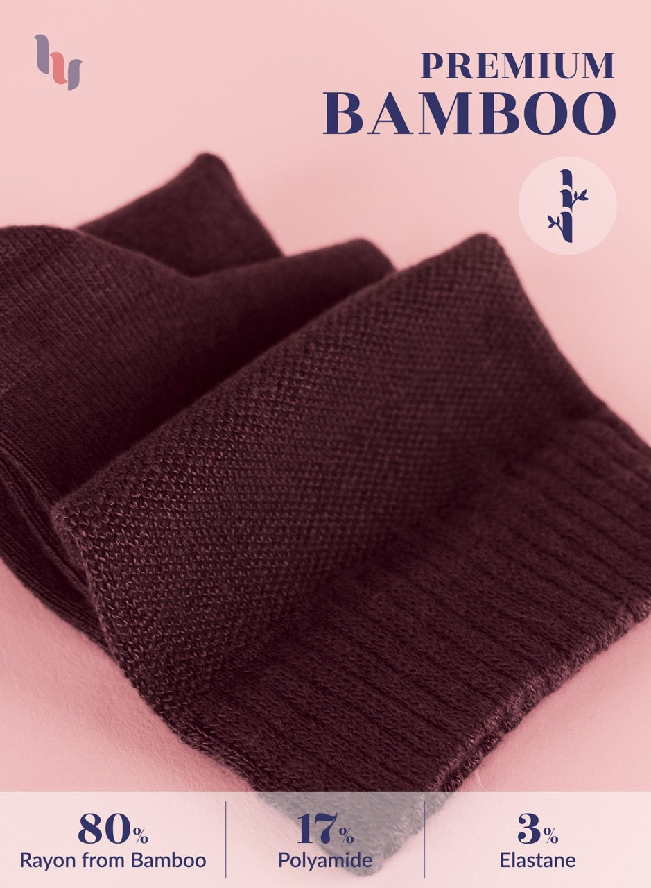 Burgundy knitted fabric with bamboo text and percentage details on a pink background