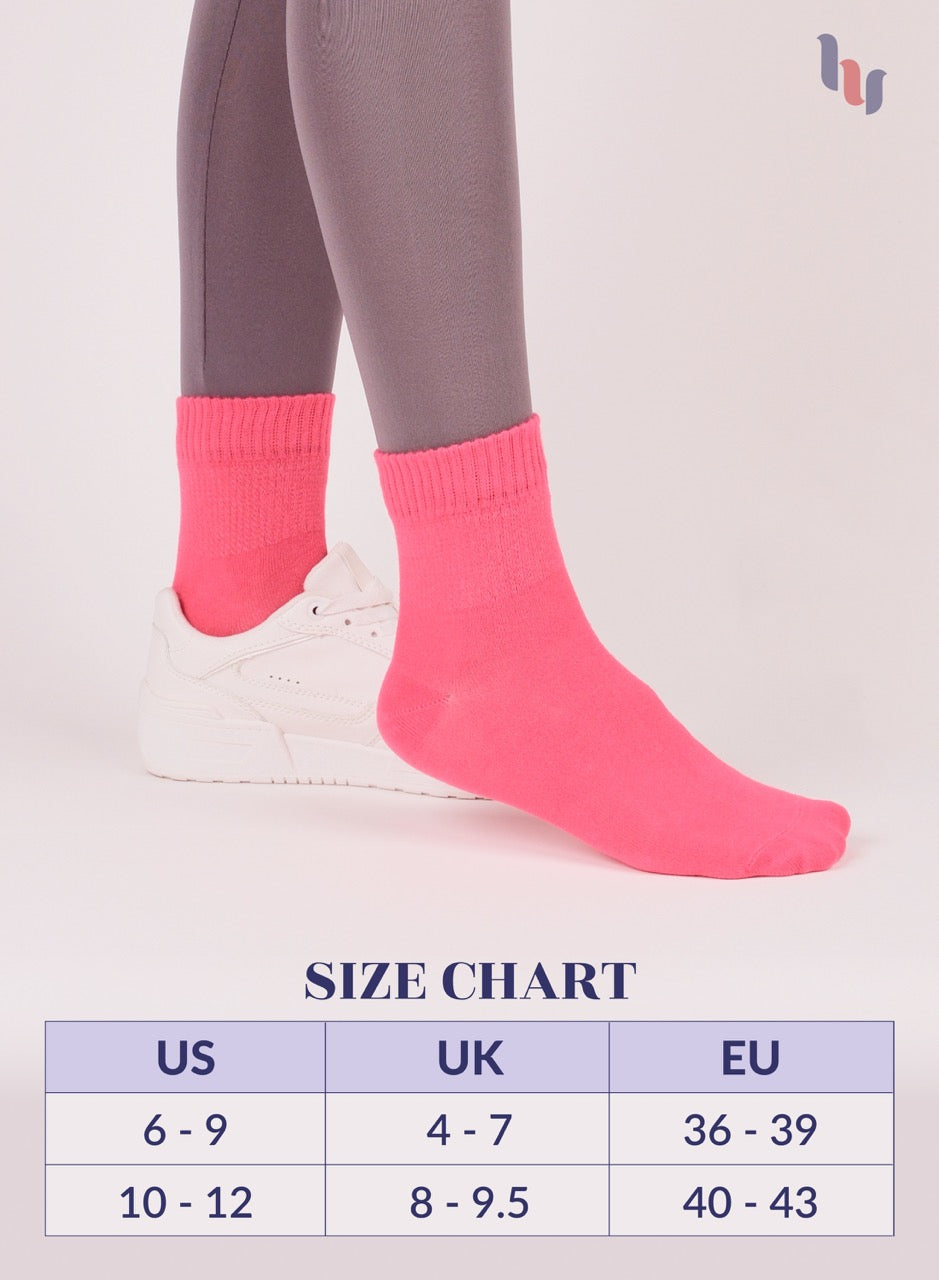Paradise Pink socks being worn with a size chart below on a light background