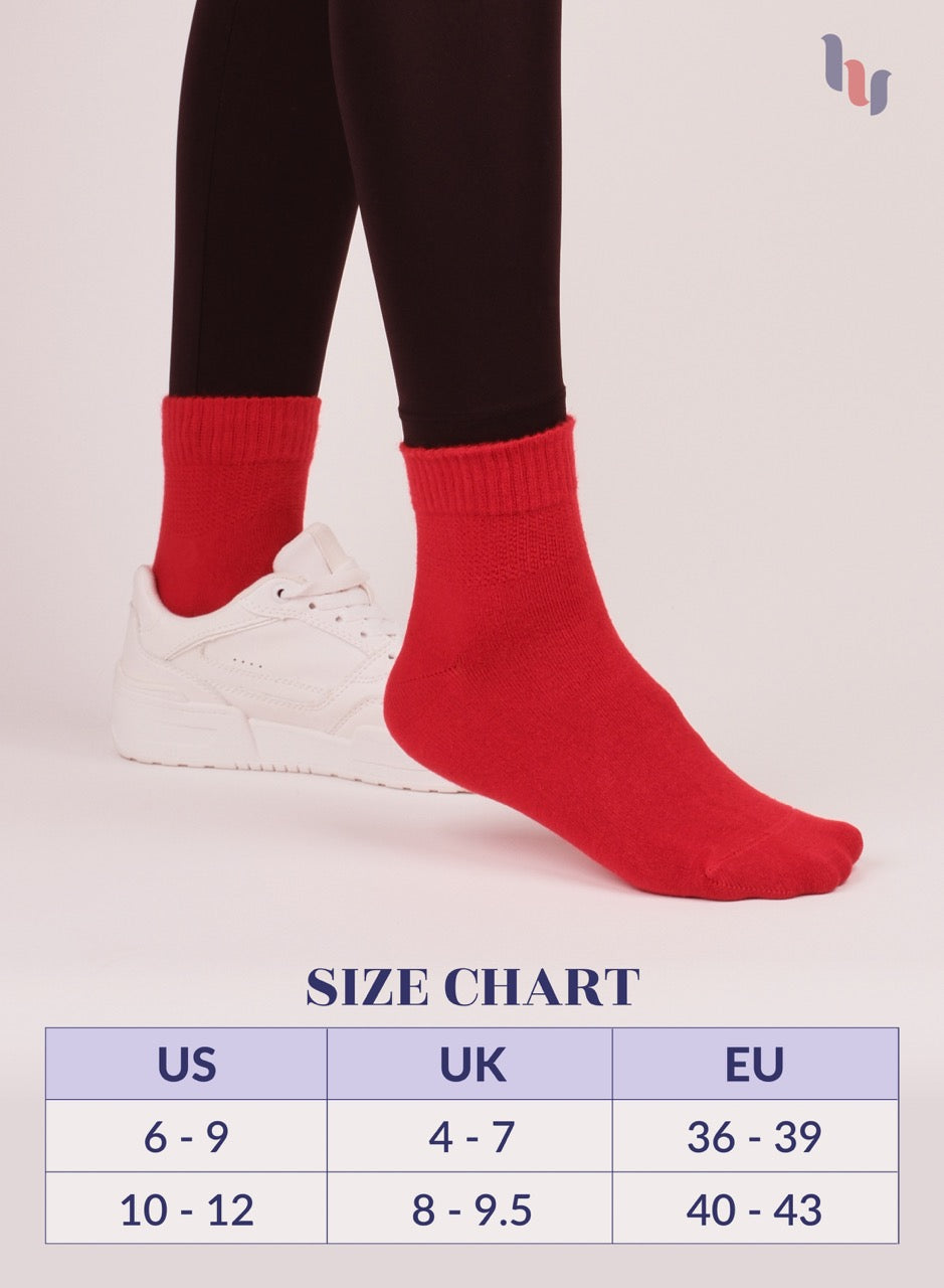 Red socks worn with black leggings and white sneakers, size chart displayed.
