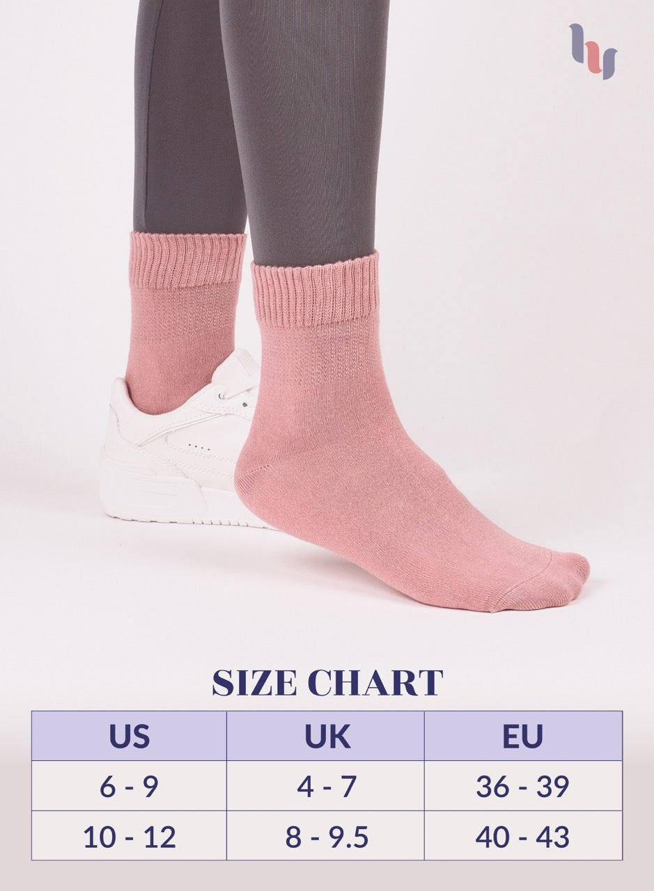 Rose cloud socks being worn with a size chart below on a white background