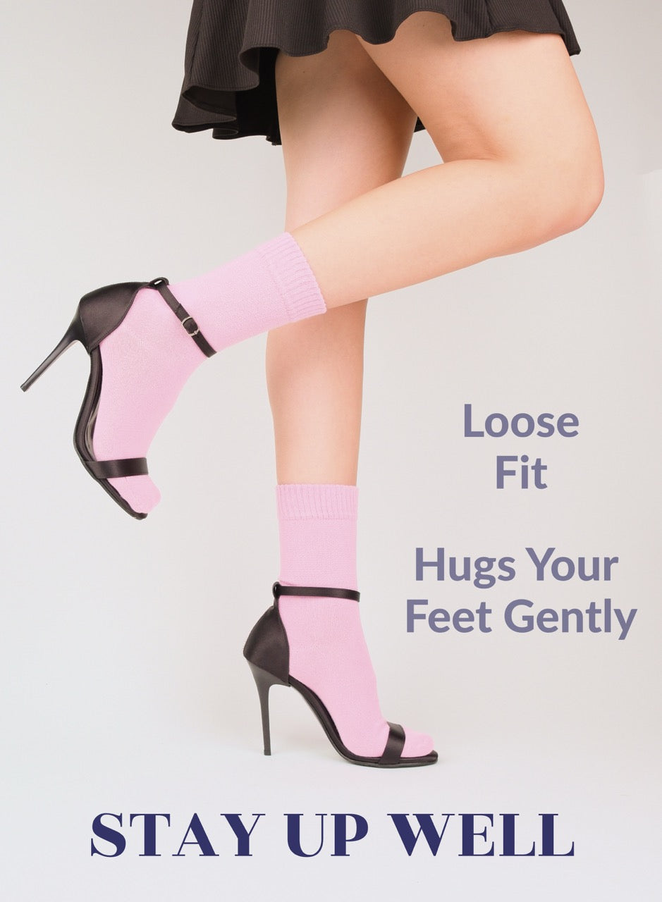 Person wearing pink socks and black high-heeled shoes with text about sock fit.