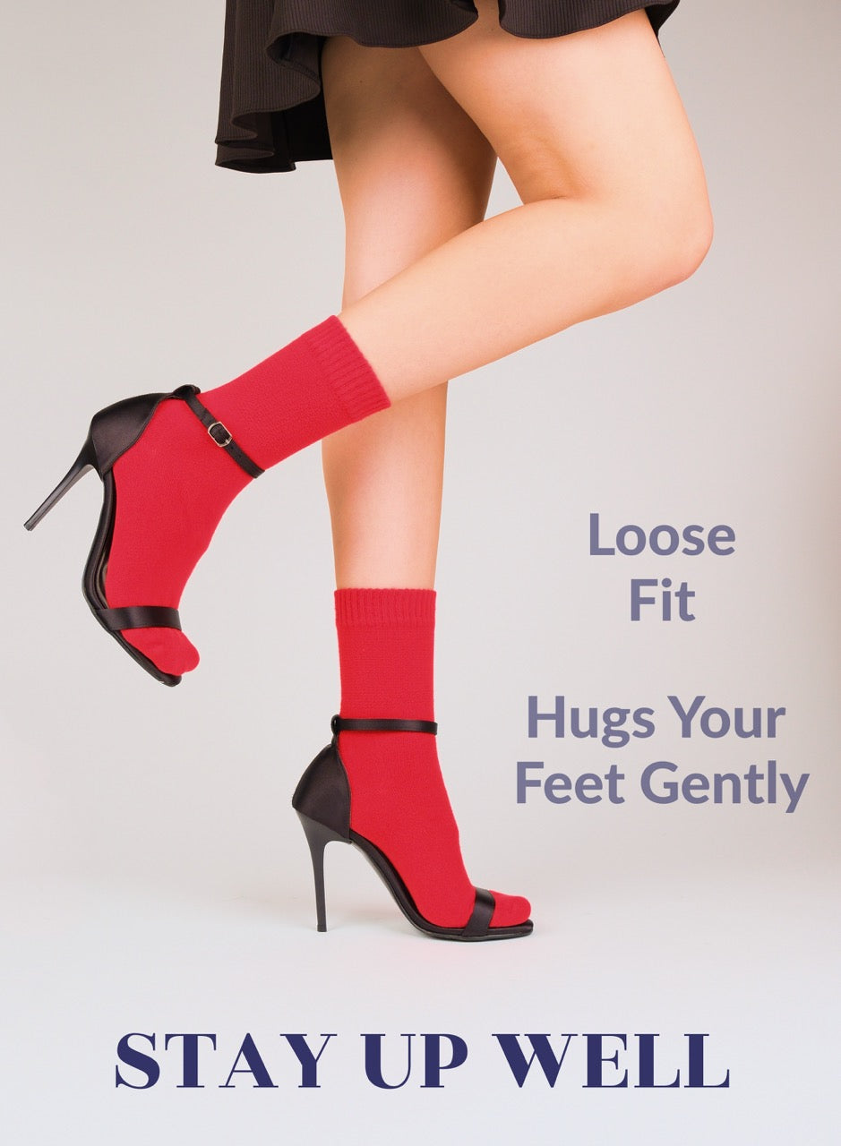 Red high socks with black shoes worn by a person on a plain background, with text about sock fit.
