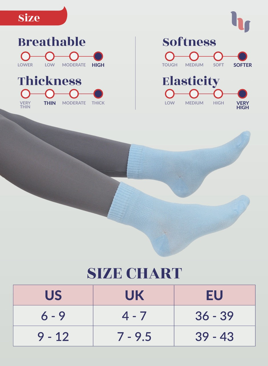 Sky blue socks being worn with a size chart below on a light gray background