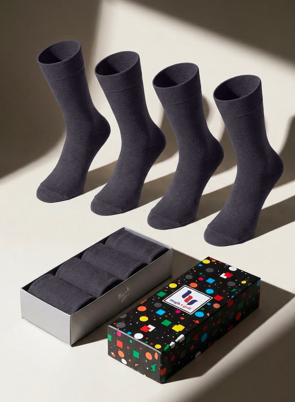 Four charcoal gray socks with a patterned gift box on a light background