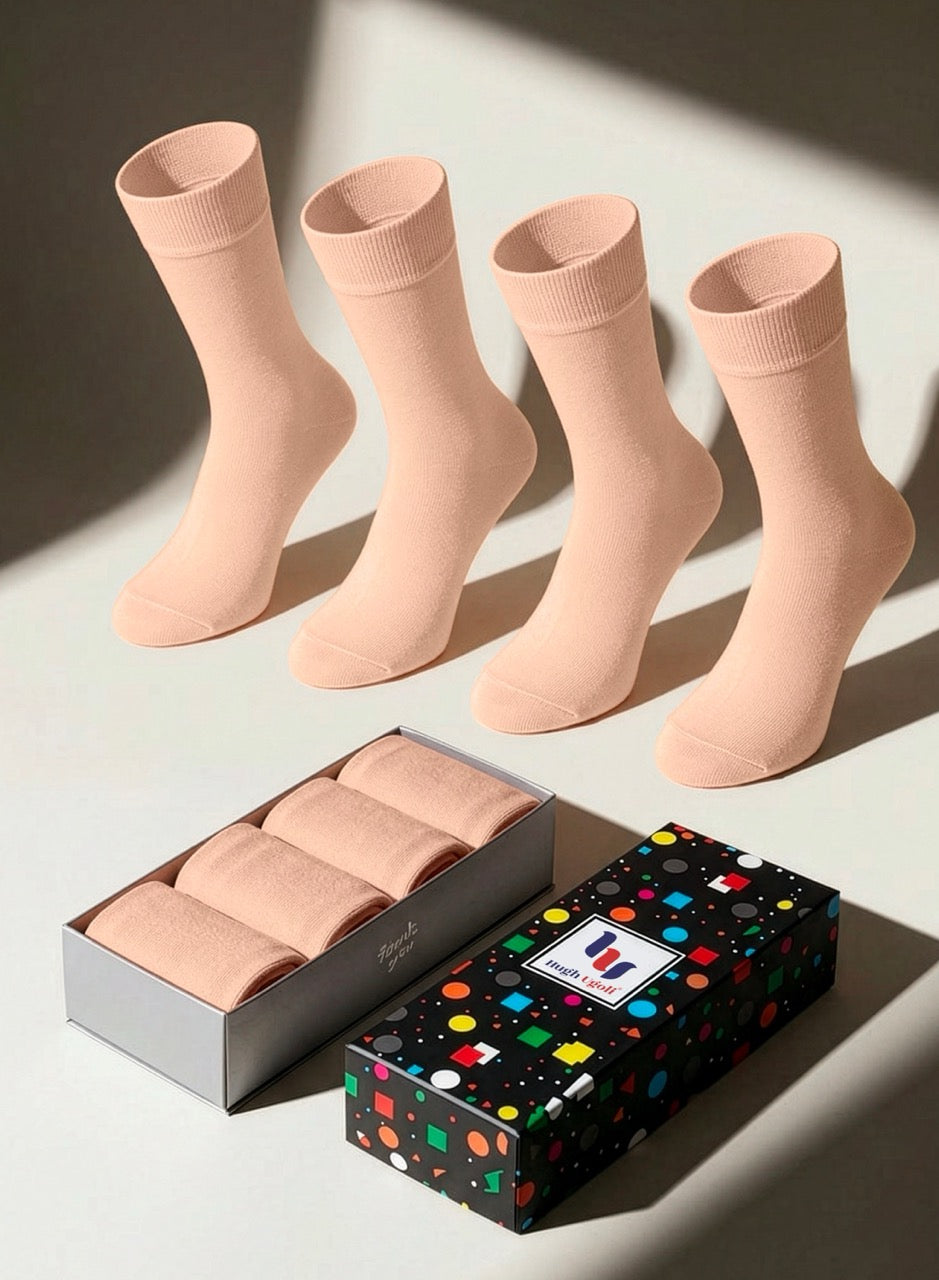 Set of peach rose socks with a branded box on a light background