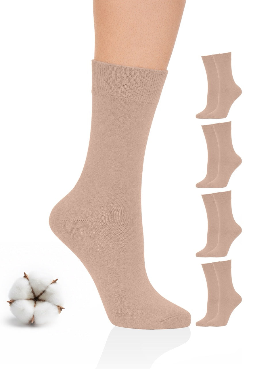 Beige socks with a cotton ball on a white background