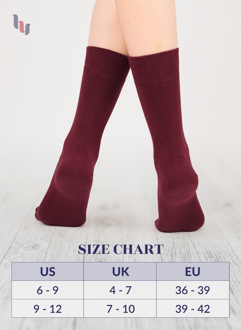 Burgundy socks being worn on a light gray background with a size chart below.