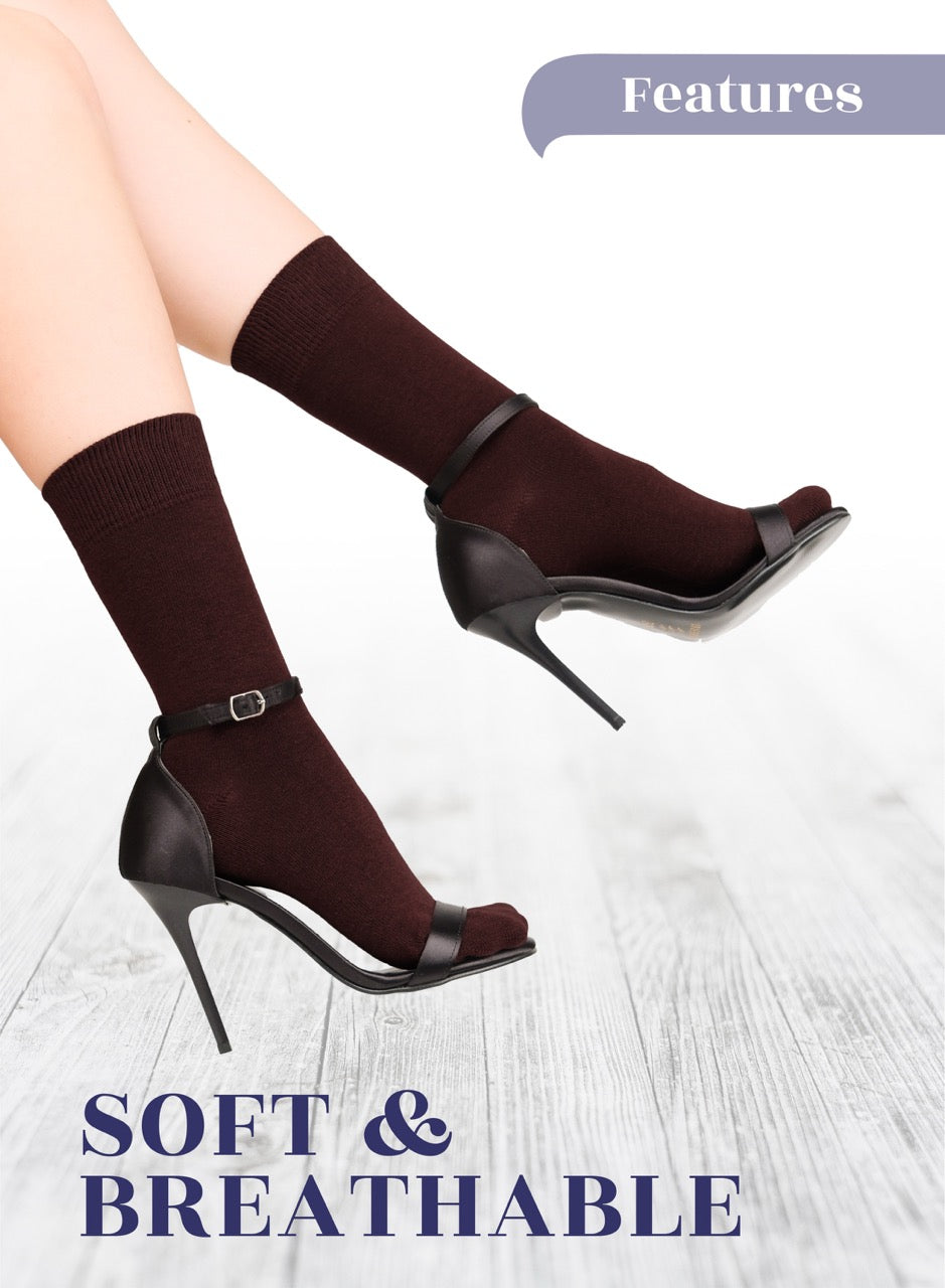 Dark Brown high-heeled shoes with socks on a light wooden floor, labeled 'Soft & Breathable'.