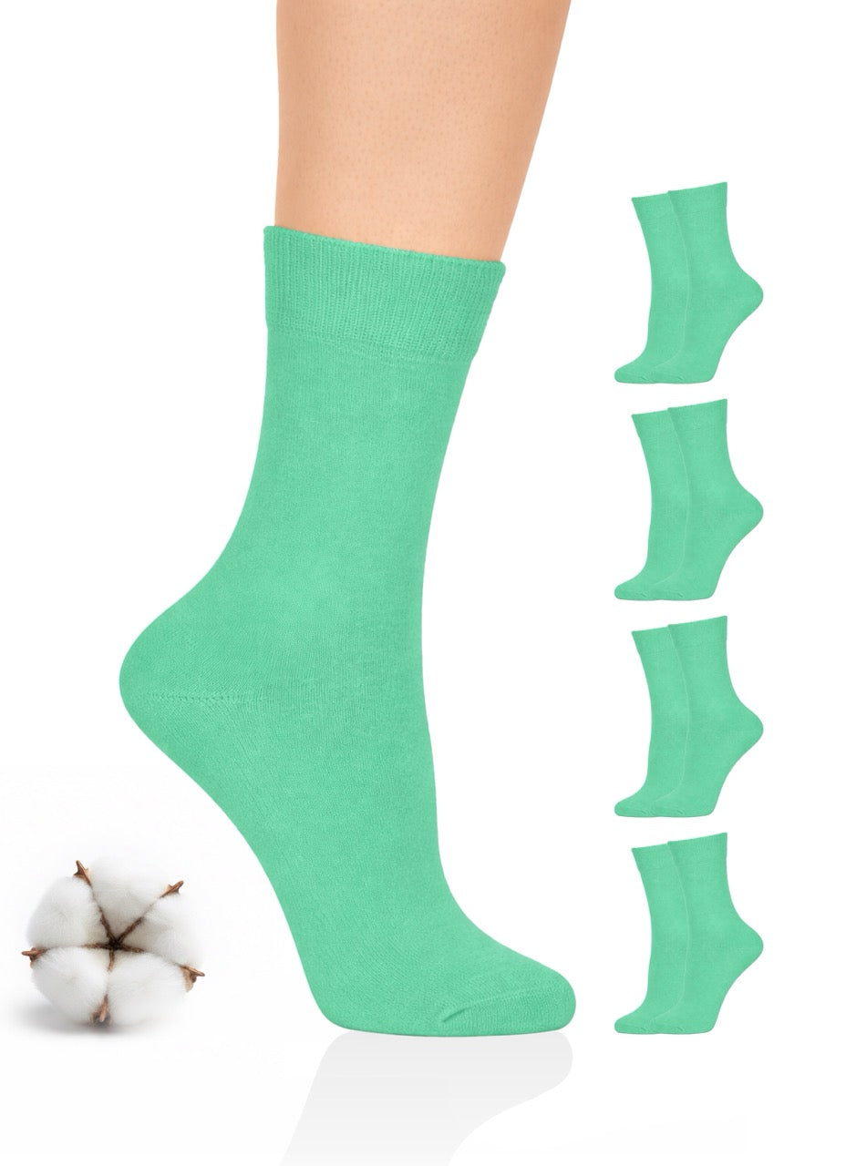 Green crew socks with a cotton ball on a white background