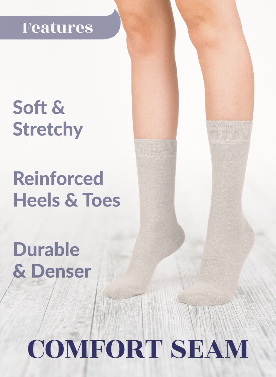 Light beige socks with text highlighting features on a light wooden floor background