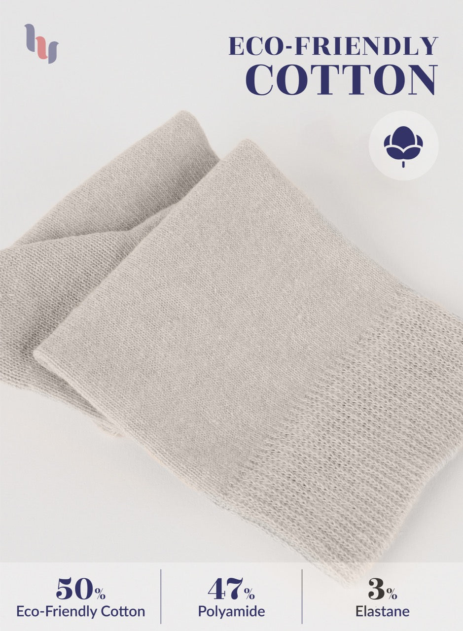 Folded light beige socks with eco-friendly cotton label on a white background
