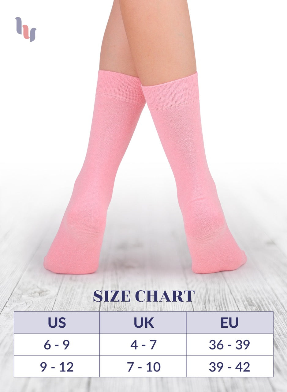 Pink crew socks on a white background with a size chart below.