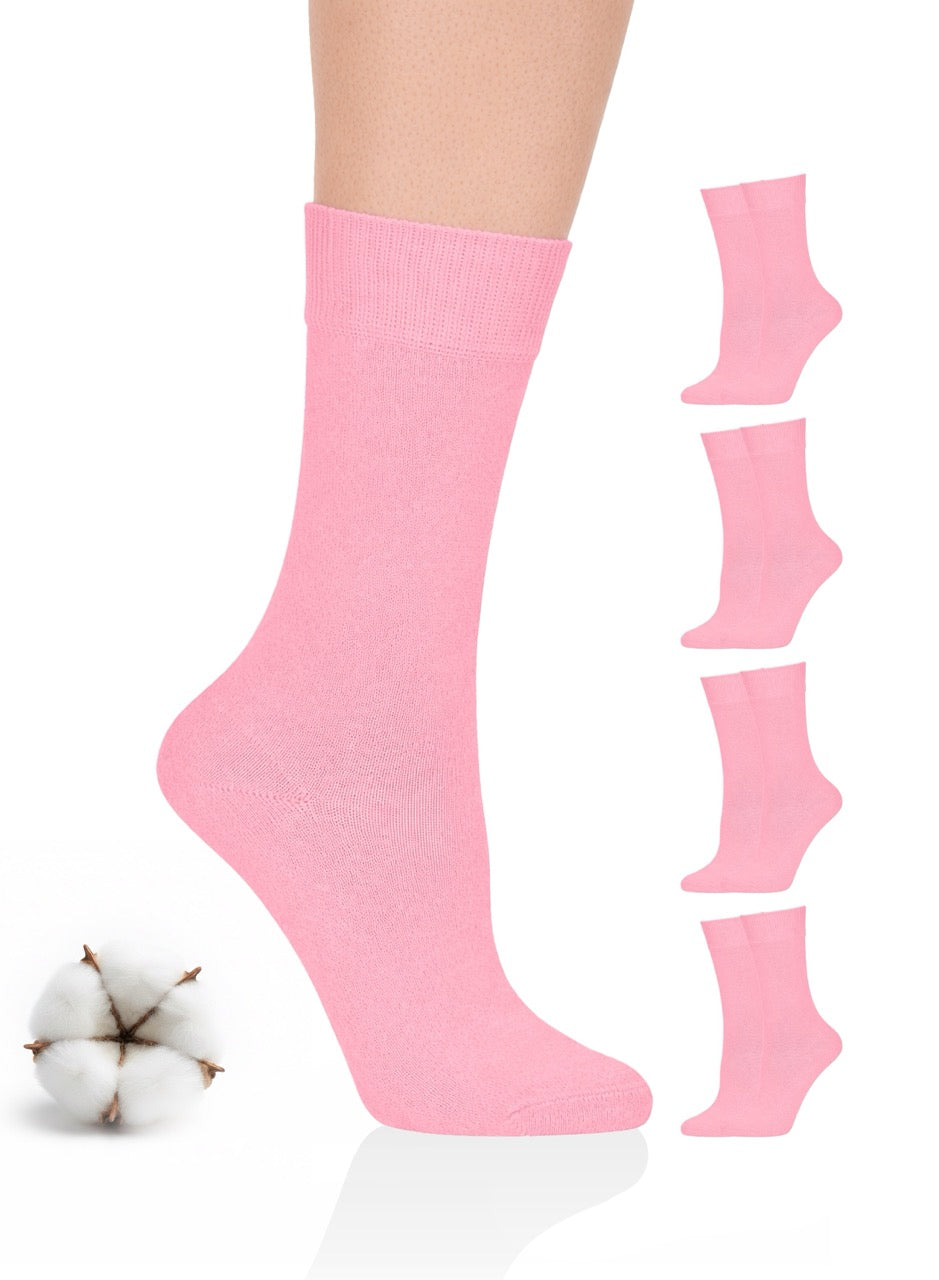 Pink crew socks with a cotton ball on a white background